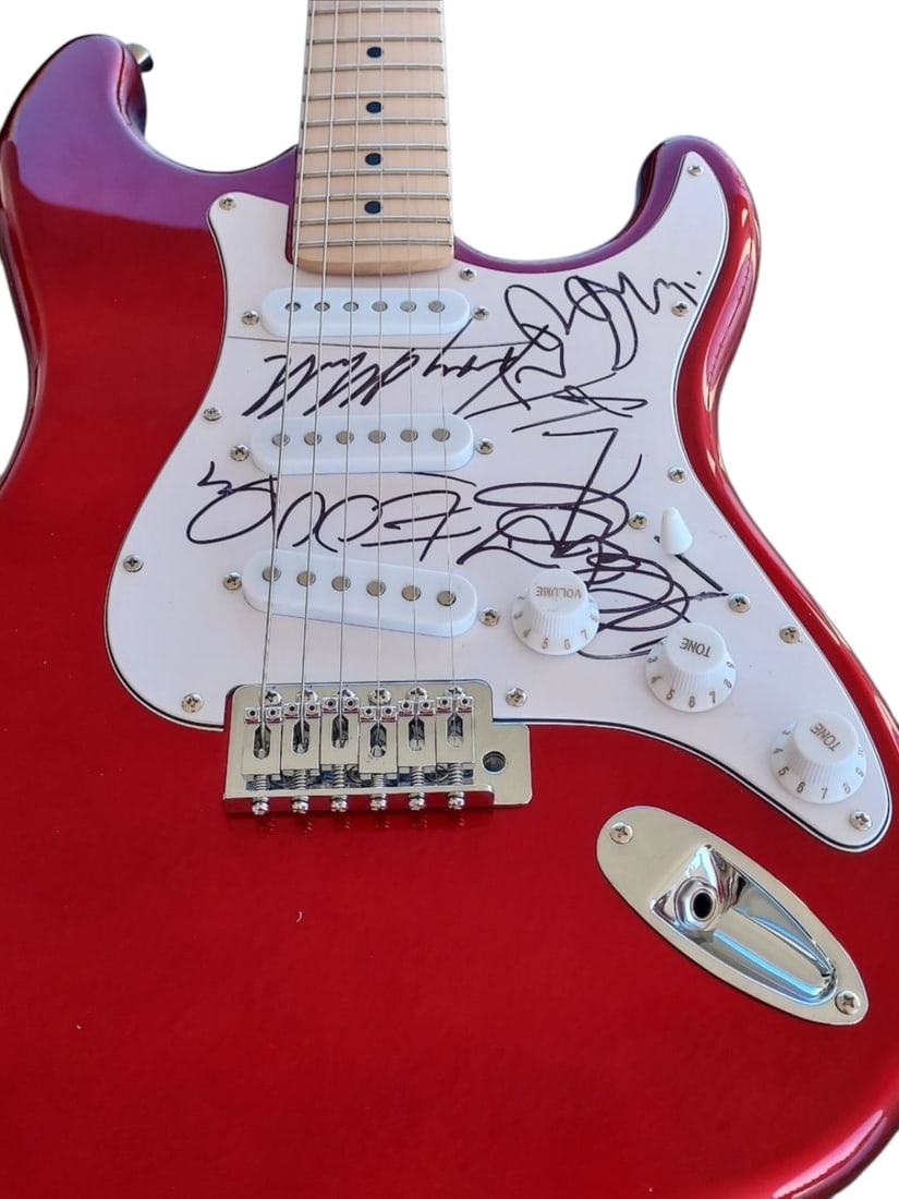 U2 Signed Electric Guitar: This lot is an electric guitar, autographed on the pickguard by The Edge, Larry Mullen Jr, Adam Clayton and Bono of U2. Item comes with third-party authentication and affixed tamper-proof holographic 