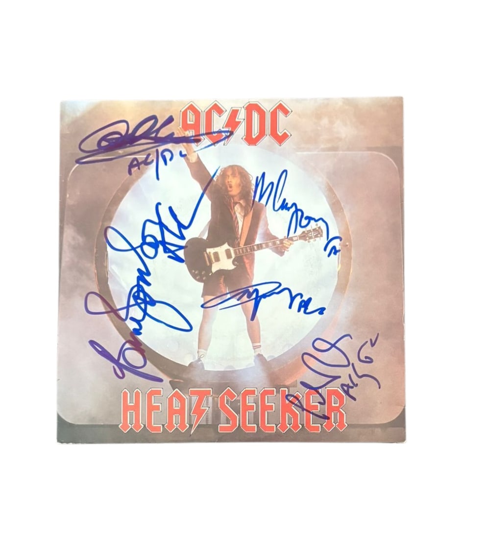 AC/DC Signed 7" Vinyl 45: This lot is a 7" vinyl 45 (Heat Seeker), autographed on the front of the vinyl cover by Brian Johnson, Angus Young, Malcolm Young, Phil Rudd and Cliff Williams of AC/DC. Item comes with third-party au