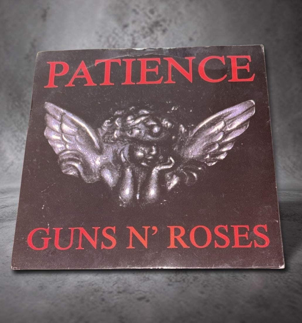 Guns N' Roses Signed Vinyl 45: This lot is a vinyl 45 (Patience), autographed by Axl Rose, Duff McKagan, Slash and Steven Adler of Guns N' Roses. Item comes with third party authentication including interactive QR code, item detail