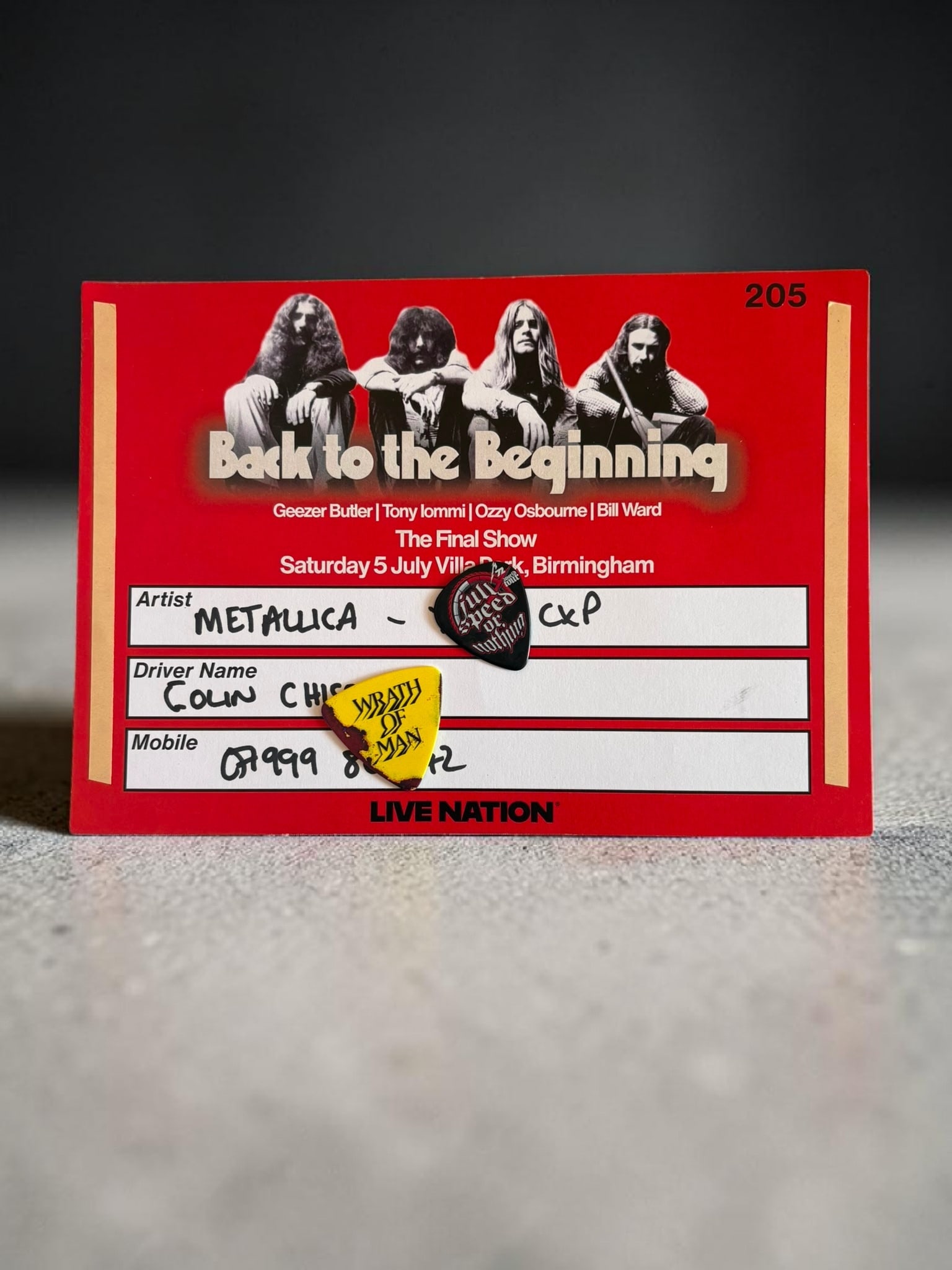 Back To The Beginning Metallica Black Sabbath Backstage Vehicle Pass With Guitar Picks: This lot is a vehicle pass from the Villa Park Black Sabbath (Back To The Beginning Concert), issued to the vehicle that was carrying James Hetfield and Robert Trujillo of Metallica to and from the co