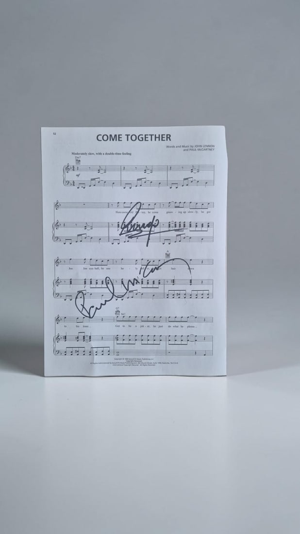 The Beatles Signed Sheet Music: This lot is a page of sheet music (Come Together), autographed by Paul McCartney and Ringo Starr of The Beatles. Item comes with third party authentication including interactive QR code, item details 