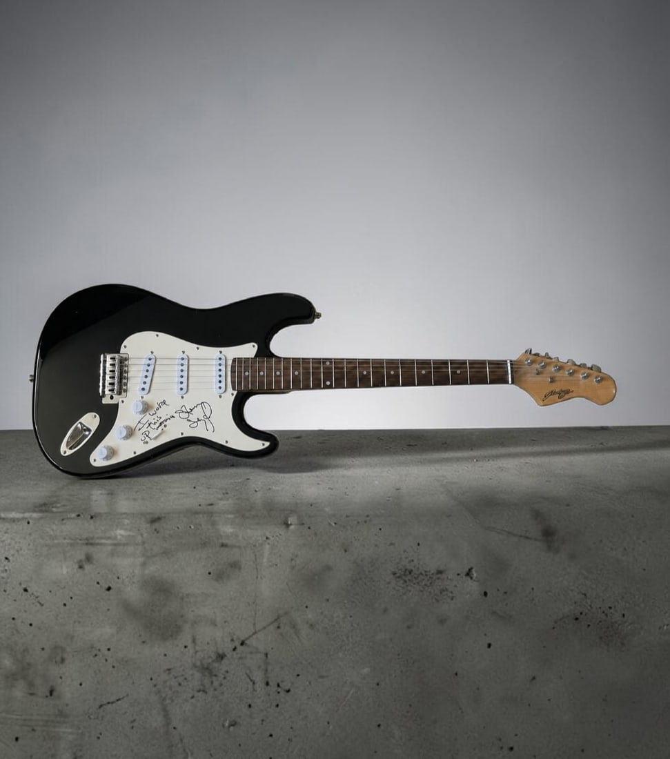 Steven Seagal Signed Stratocaster Style Electric Guitar. ACOA Authenticated: This lot is a Stratocaster style electric guitar, autographed by Steven Seagal. Item comes with third party authentication including interactive QR code, item details and scoring. Item comes with ACOA