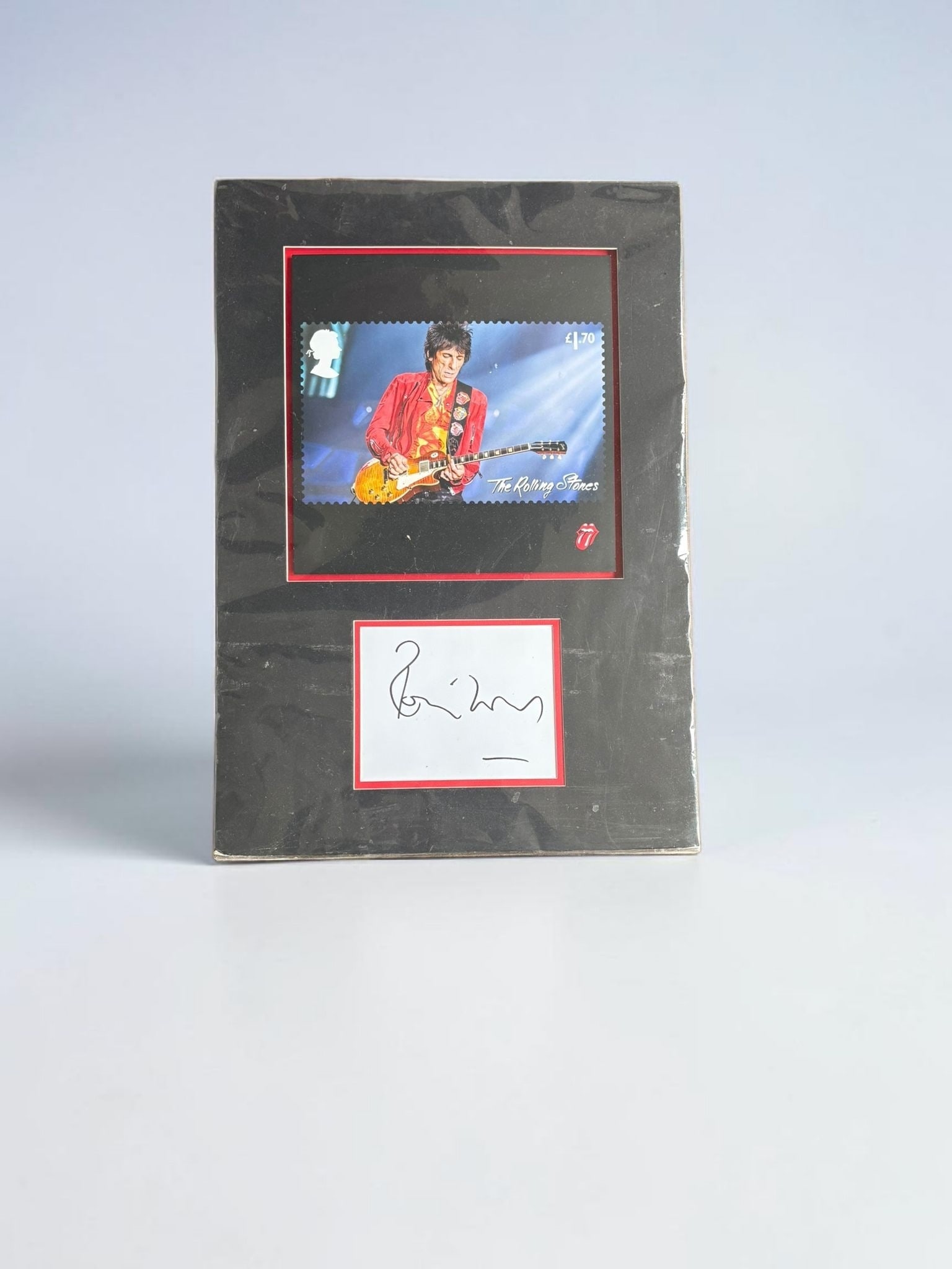 Ronnie Wood The Rolling Stones Signed Mounted Display: This lot is a mounted display, consisting of postage stamp style print and white card, autographed by Ronnie Wood of The Rolling Stones. Item comes with third party authentication including interactiv