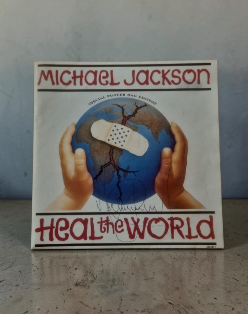 Michael Jackson Heal The World Signed 7" Vinyl: This lot is a 7" vinyl (Heal The World), autographed on the front of the vinyl cover in black biro pen by Michael Jackson. If you wish to upgrade to a third party authentication with holographic QR co