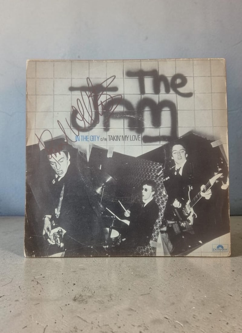 Paul Weller The Jam In The City Signed 7" Vinyl Single: This lot is a 7" vinyl single (In The City), autographed on the front of the vinyl cover by Paul Weller of The Jam. If you wish to upgrade to a third party authentication with holographic QR code and 
