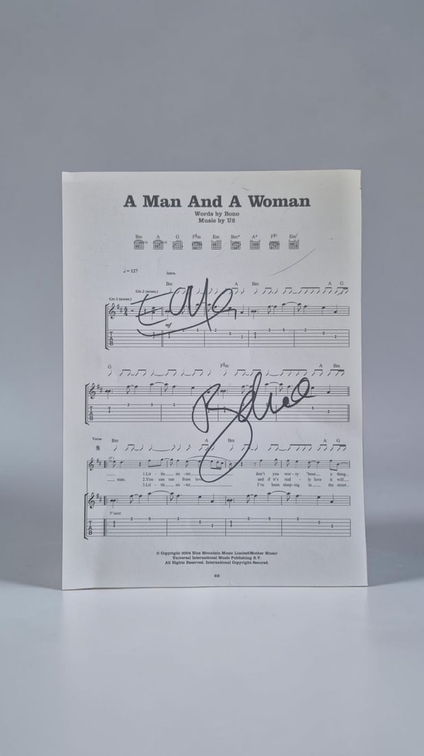 U2 Signed Sheet Music: This lot is a page of sheet music (A Man And A Woman), autographed by Bono and The Edge of U2. If you wish to upgrade to a third party authentication with holographic QR code and item scoring, an addi