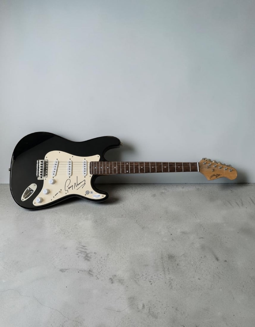 Gary Numan Signed Stratocaster Style Electric Guitar ACOA Authenticated: This lot is a Stratocaster style electric guitar, autographed by Gary Numan. Item comes with ACOA authentication. If you wish to upgrade to a third party authentication with holographic QR code and it