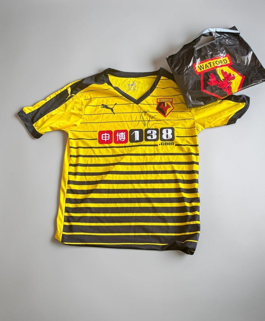 Elton John Signed Watford FC Shirt 2016: This lot is a Watford FC shirt, purchashed on the 3rd February 2016 and signed by Elton John at HMV in Oxford Street London. If you wish to upgrade to a third party authentication with holographic QR 