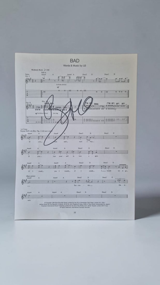 Bono U2 Signed Sheet Music: This lot is a page of sheet music (Bad), autographed by Bono of U2. If you wish to upgrade to a third party authentication with holographic QR code and item scoring, an additional charge of 30 UK Poun