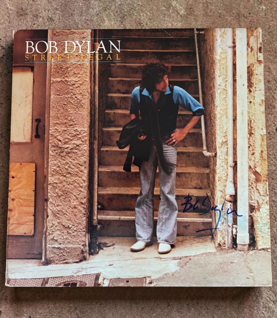Bob Dylan Signed Vinyl LP: This lot is a vinyl LP (Street Legal), autographed by Bob Dylan. If you wish to upgrade to a third party authentication with holographic QR code and item scoring, an additional charge of 30 UK Pound w