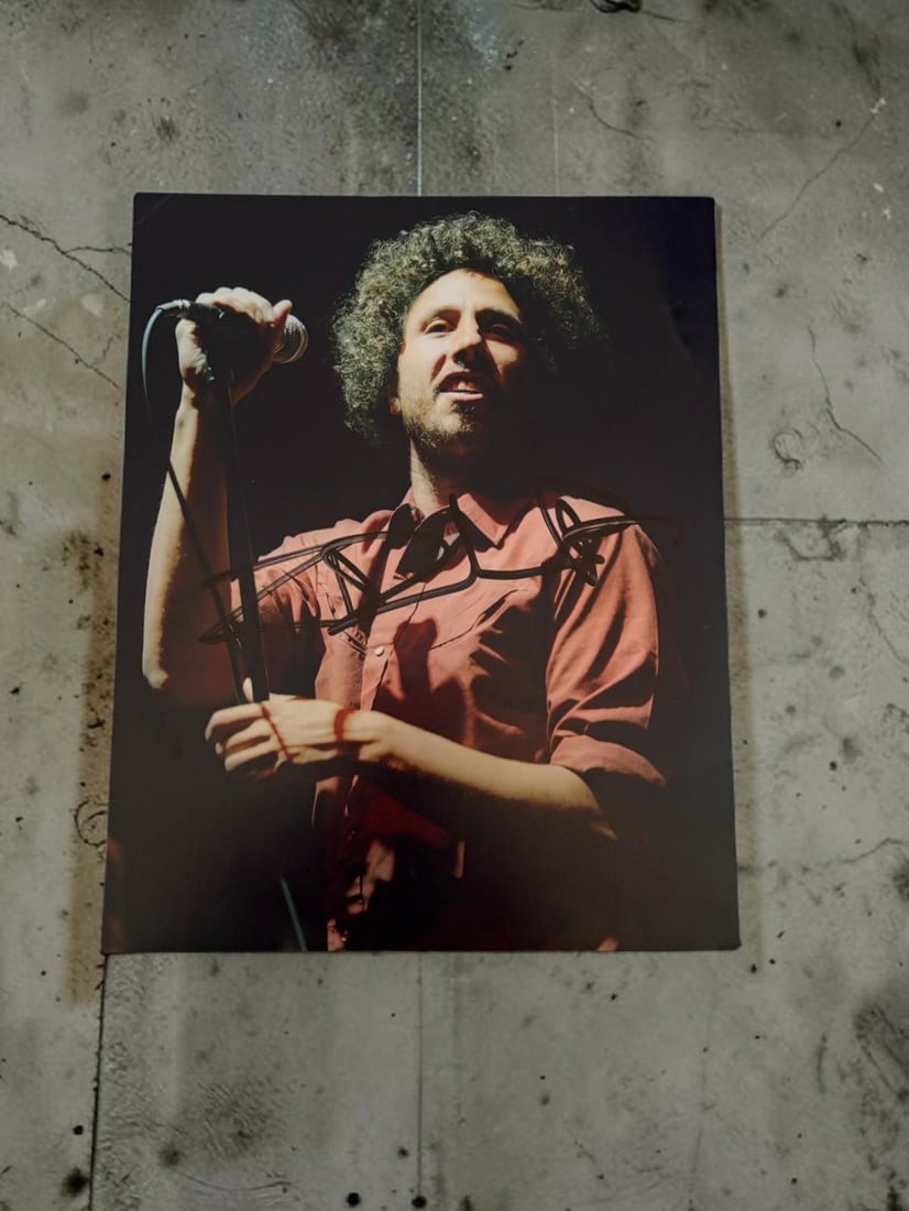 Rage Against The Machine Signed Photograph: This lot is a 10x8" photograph, autographed by Zach De La Rocha of Rage Against The Machine. If you wish to upgrade to a third party authentication with holographic QR code and item scoring, an