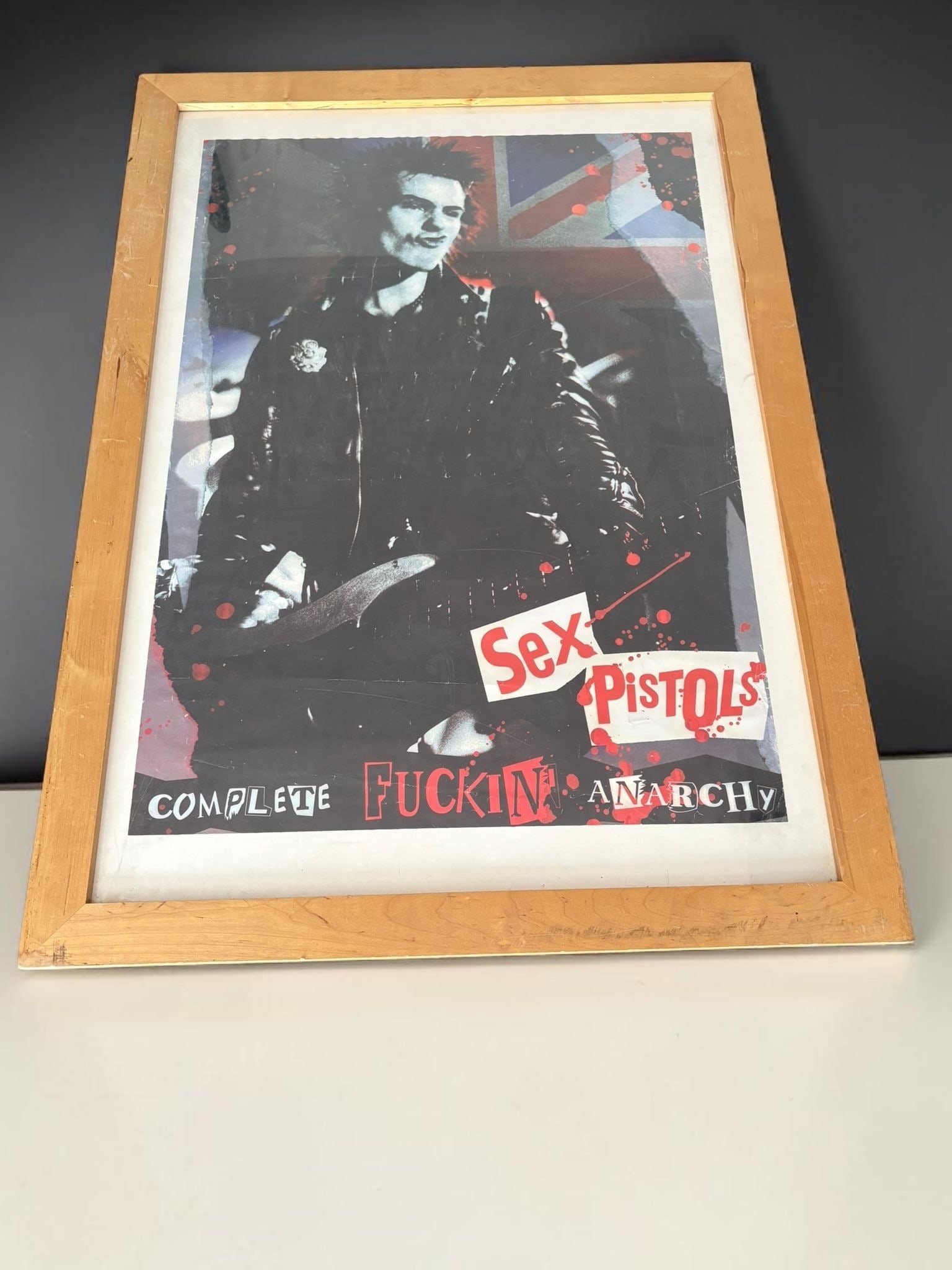 Sex Pistols Original 1977 Sid Vicious, Original 1977 Anarchy Poster: This lot is a framed original 1977 poster, poster is pasted on a backboard. Item comes with certificate of authenticity.