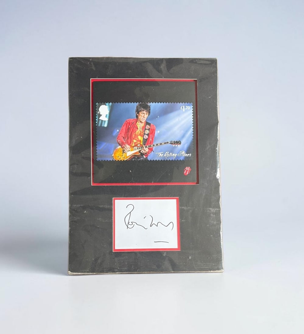 Ronnie Wood The Rolling Stones Signed Mounted Display: This lot is a mounted display, consisting of postage stamp style print and white card, autographed by Ronnie Wood of The Rolling Stones. If you wish to upgrade to a third party authentication with hol