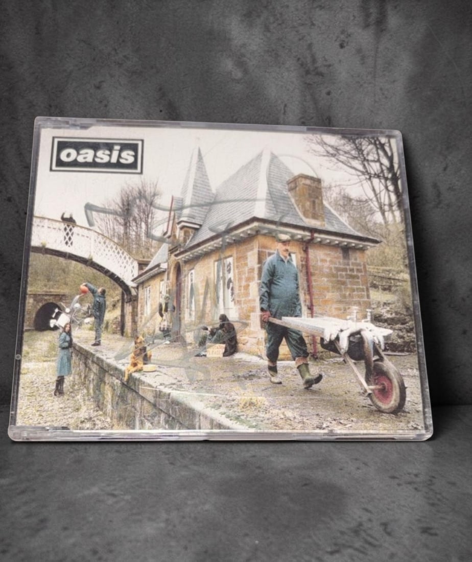 Oasis Signed CD Single: This lot is a CD single (Some Might Say), autographed by Noel Gallagher and Liam Gallagher of Oasis. If you wish to upgrade to a third party authentication with holographic QR code and item scoring, a