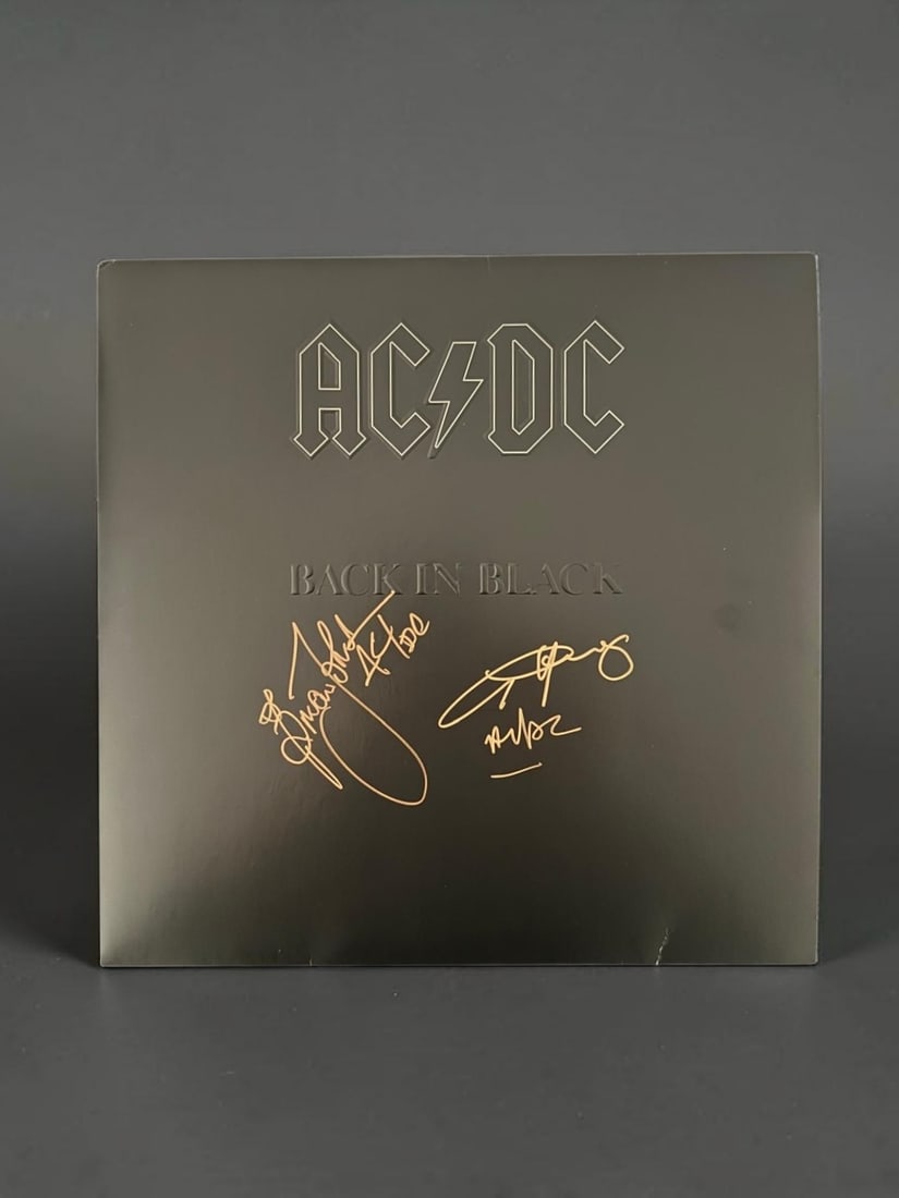 AC/DC Signed Back In Black Vinyl LP With Exact Proof From Time Of Signing: This lot is a vinyl LP (Back In Black), a brand new anniversary edition of (Back In Black), autographed by Brian Johnson and AngusYoung of AC/DC. Photo comes with exact proof from time of signing. If