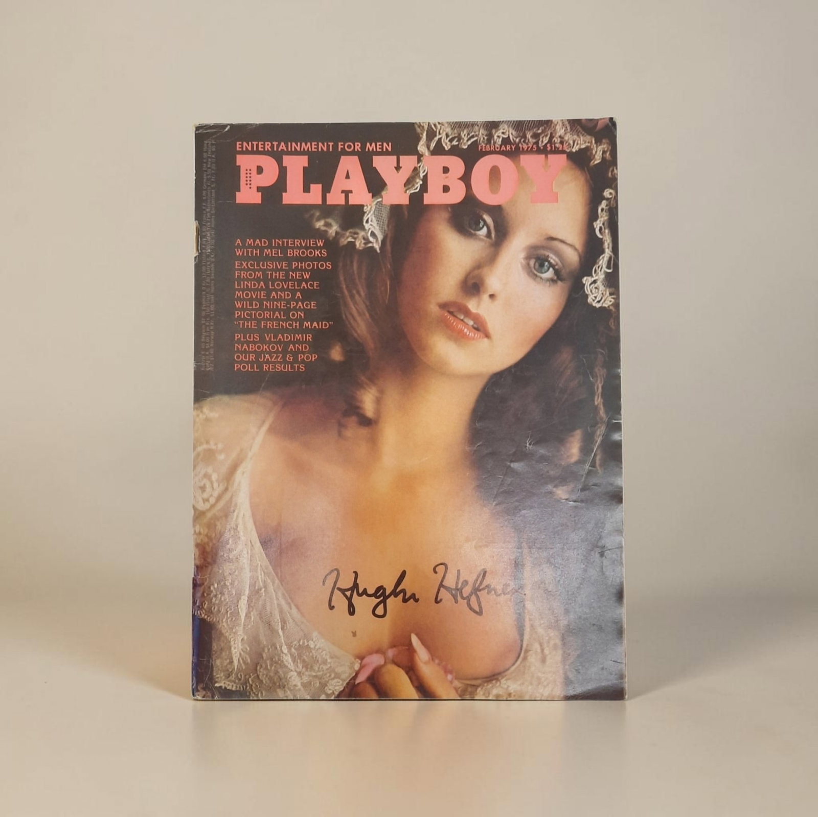 Hugh Hefner Signed Playboy Magazine: This lot is a Playboy magazine (February 1975) autographed by Hugh Hefner. If you wish to upgrade to a third party authentication with holographic QR code and item scoring, an additional charge of 30 