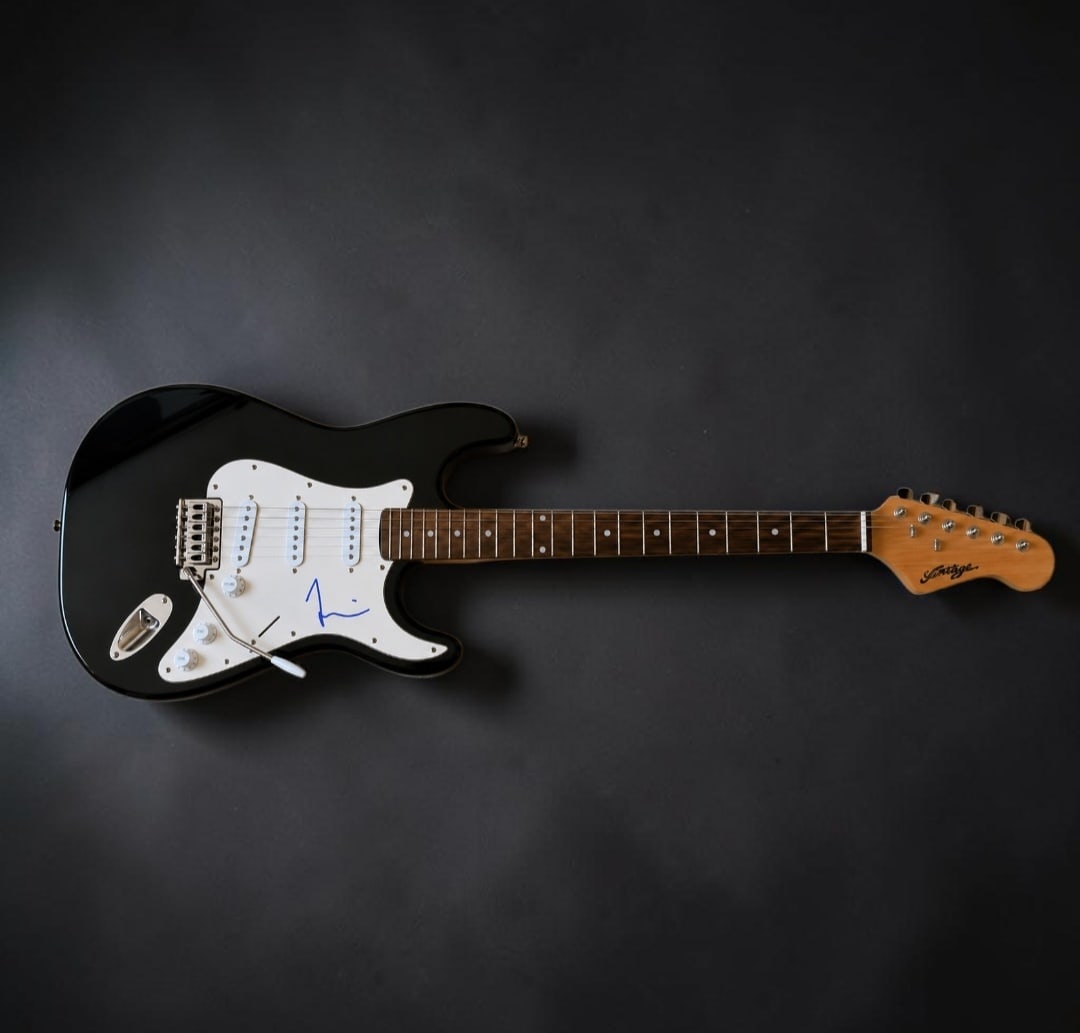 Taylor Hawkins Foo Fighters Signed Stratocaster Style Electric Guitar: This lot is a Stratocaster style electric guitar, autographed by Taylor Hawkins of the Sex Pistols. If you wish to upgrade to a third party authentication with holographic QR code and item scoring, an