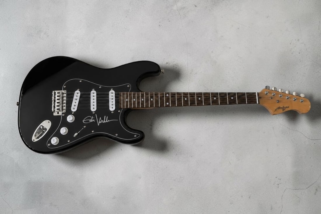 Eddie Vedder Pearl Jam Signed Electric Guitar: This lot is an electric guitar, autographed on the pickguard by Eddie Vedder of Pearl Jam. If you wish to upgrade to a third party authentication with holographic QR code and item scoring, an addition