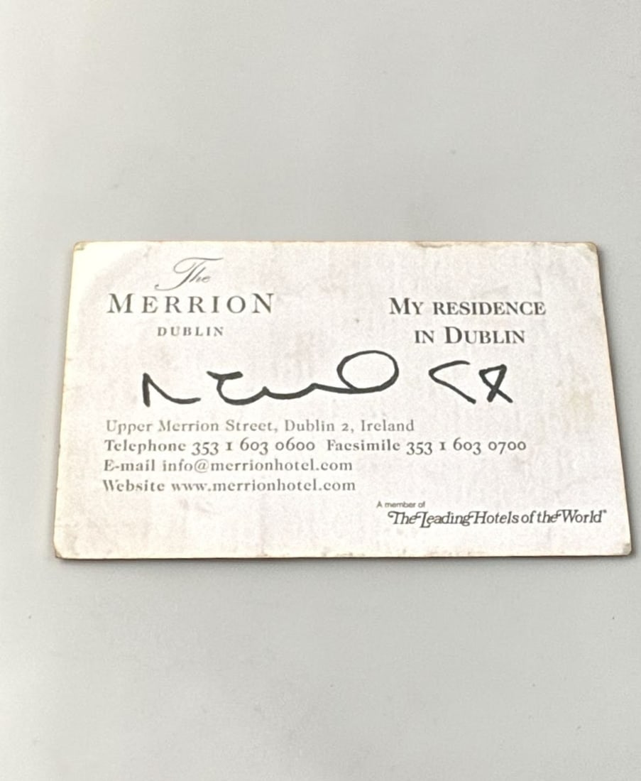 Noel Gallagher Oasis Signed Business Card: This lot is a business card (The Merrion Hotel, Dublin), autographed by Noel Gallagher of Oasis. If you wish to upgrade to a third party authentication with holographic QR code and item scoring, an ad