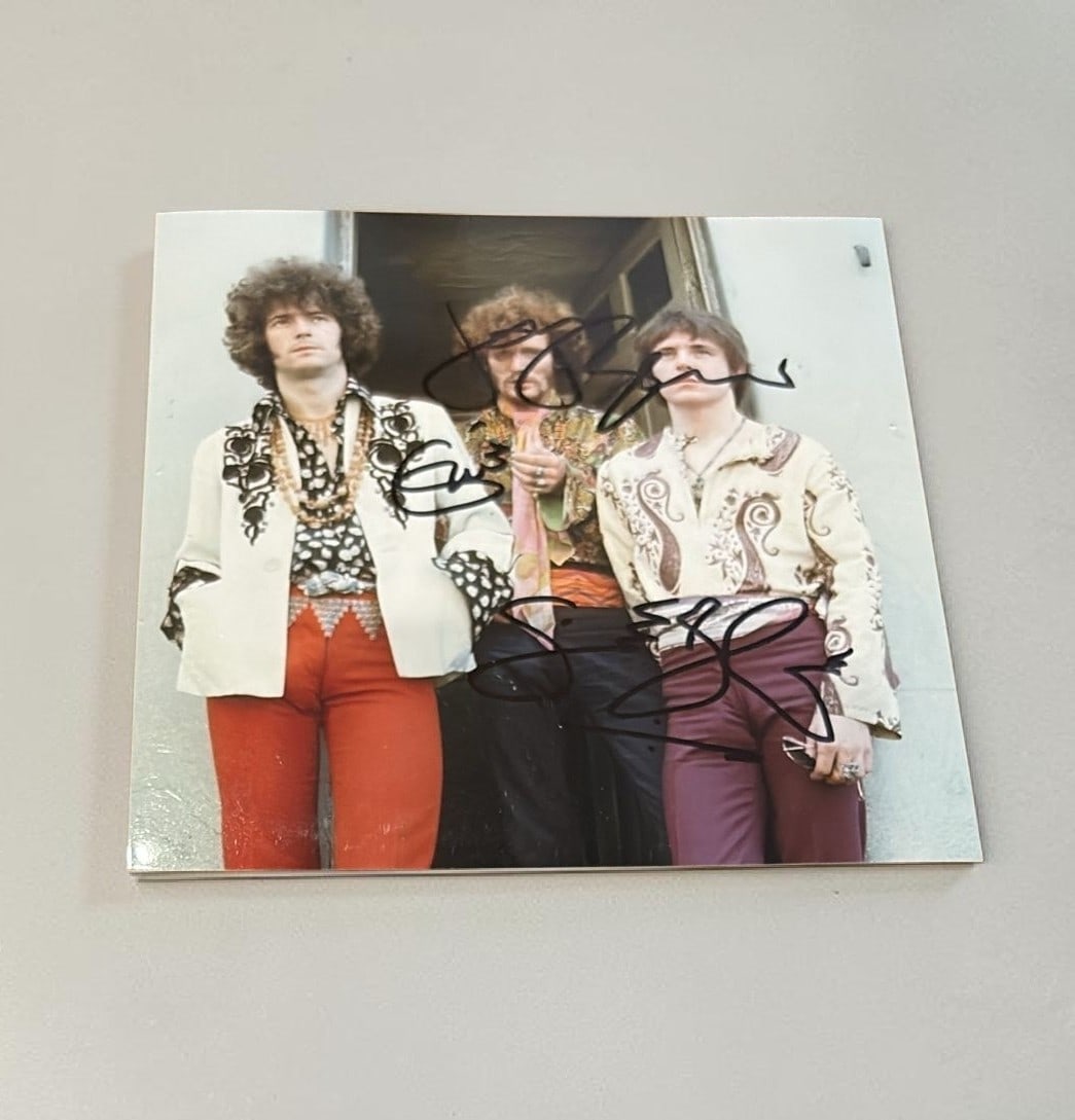 Cream Signed Photograph: This lot is a 5x5" photograph, autographed by Eric Clapton, Ginger Baker and Jack Bruce of Cream. If you wish to upgrade to a third party authentication with holographic QR code and item scoring, an a