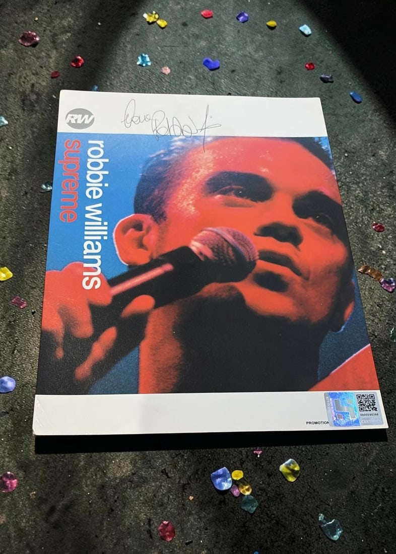 Robbie Williams Signed Promotional Card: This lot is a 10x8" EMI promotional card (Supreme), autographed by Robbie Williams. If you wish to upgrade to a third party authentication with holographic QR code and item scoring, an additional char