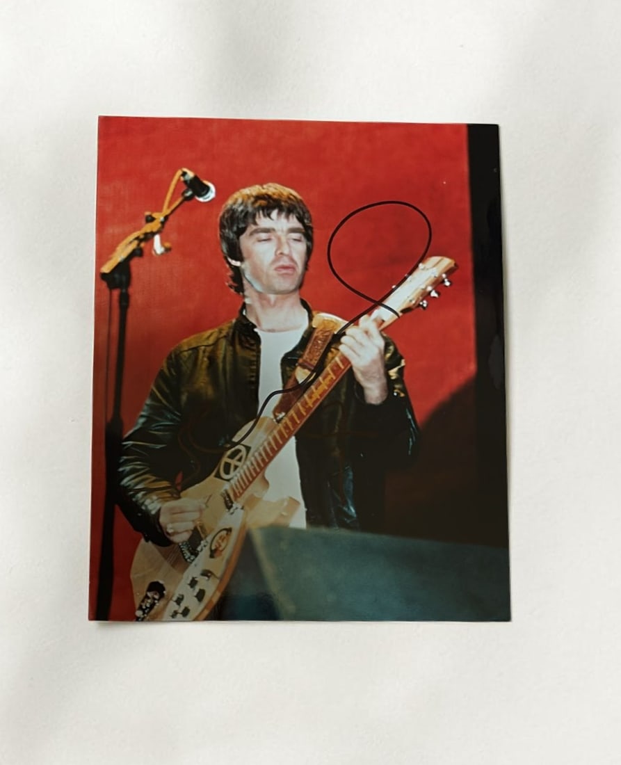 Noel Gallagher Oasis Signed Photograph: This lot is a 10 x 8" photograph, autographed by Noel Gallagher of Oasis. If you wish to upgrade to a third party authentication with holographic QR code and item scoring, an additional charge of 30 U