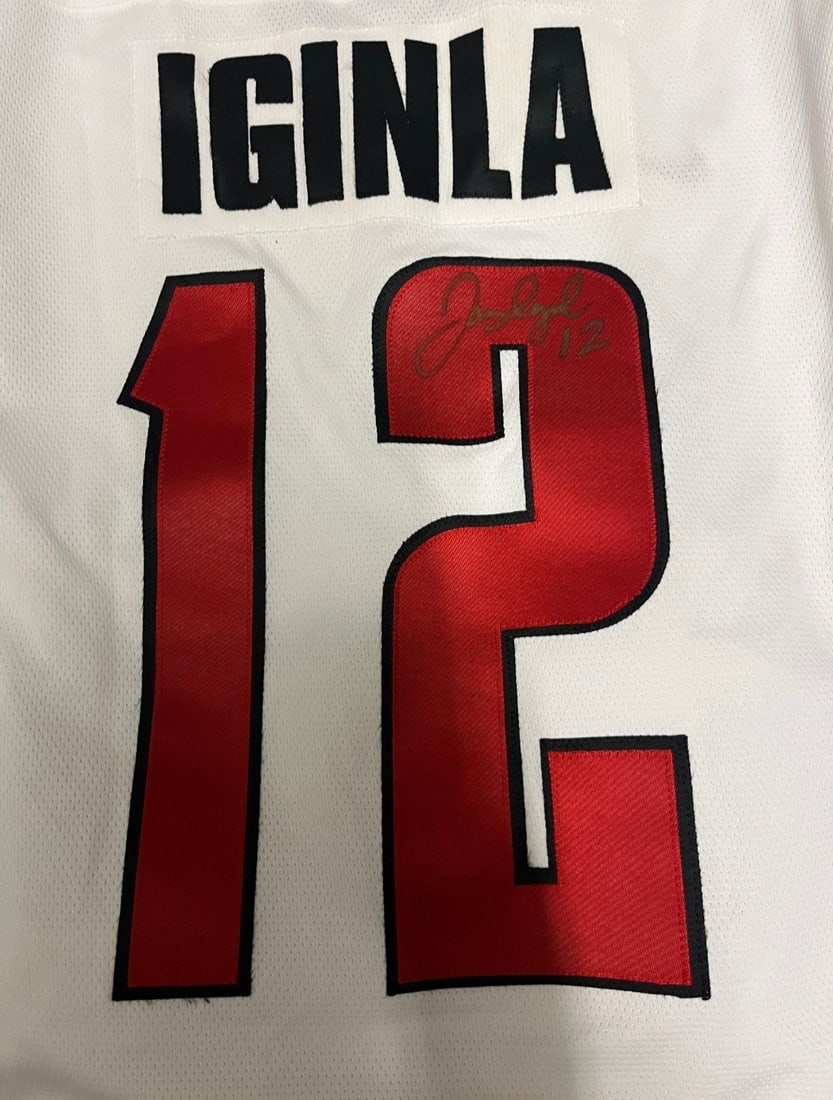 Jerome Iginla Signed Team Canada Olympic Jersey: This lot is a Team Canada Olympic Jersey, autographed by Jerome Iginla. If you wish to upgrade to a third party authentication with holographic QR code and item scoring, an additional charge of 30 UK 