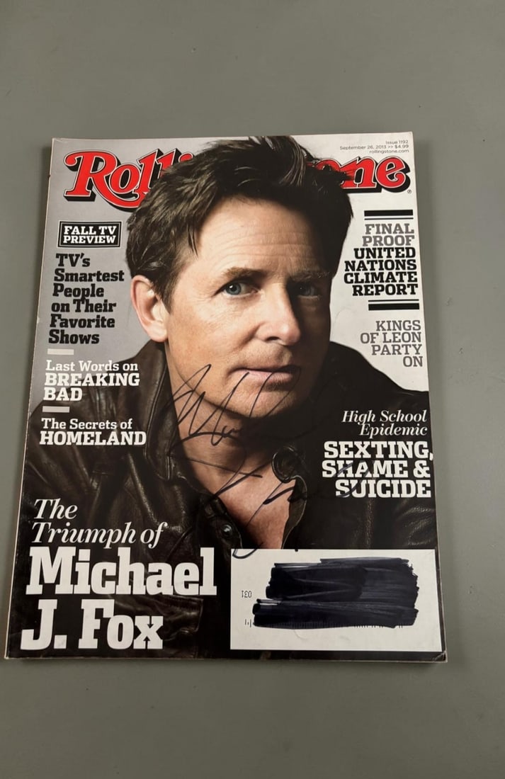 Michael J Fox Signed Magazine: This lot is a Rolling Stones magazine (September 2013), autographed on the front cover by Michael J Fox. If you wish to upgrade to a third party authentication with holographic QR code and item scorin