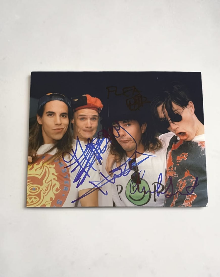 Red Hot Chili Peppers Signed Photograph: This lot is a 10x8" photograph, autographed by Anthony Kiedis, Chad Smith and Flea of the Red Hot Chili Peppers. If you wish to upgrade to a third party authentication with holographic QR code and