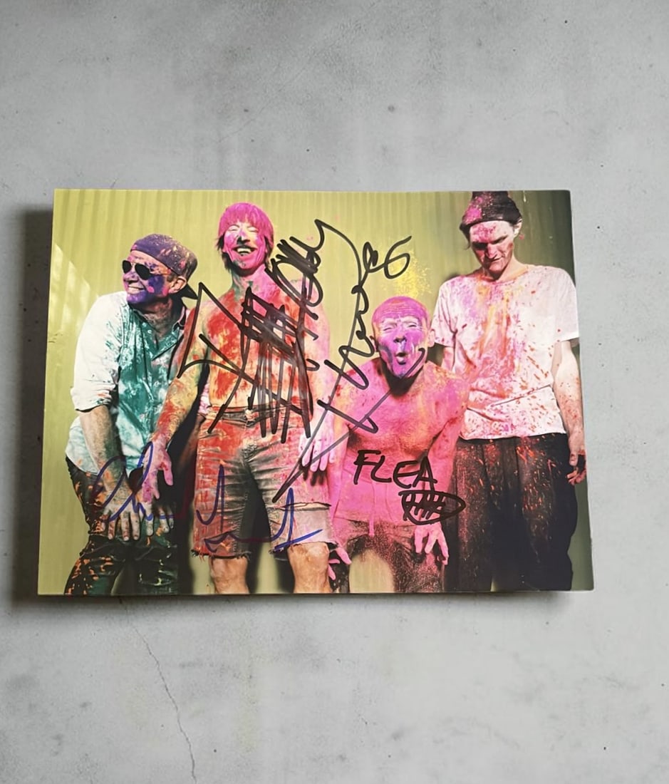 Red Hot Chili Peppers Signed Photograph: This lot is a 10x8" photograph, autographed by Anthony Kiedis, Chad Smith and Flea of the Red Hot Chili Peppers. If you wish to upgrade to a third party authentication with holographic QR code and