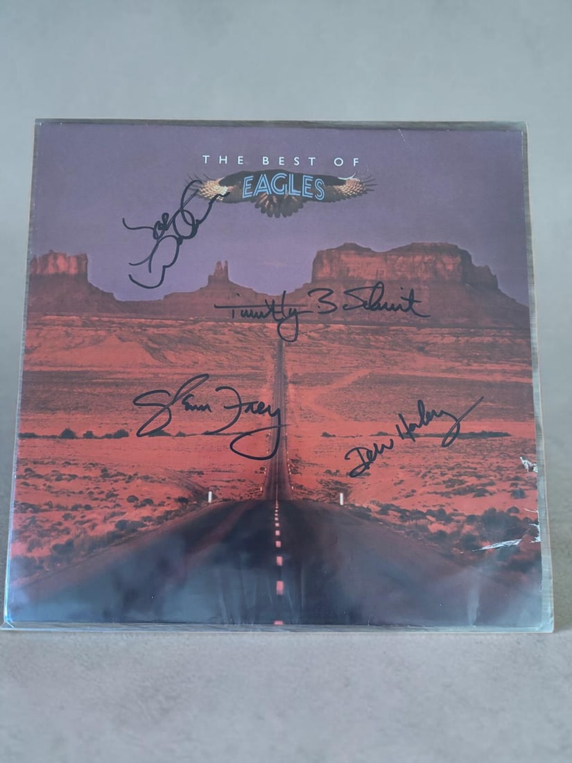 Eagles Signed Vinyl LP: This lot is a vinyl LP (The Best Of The Eagles), autographed by Joe Walsh, Don Henley, Glenn Frey and Timothy B. Schmit of the Eagles. If you wish to upgrade to a third party authentication with