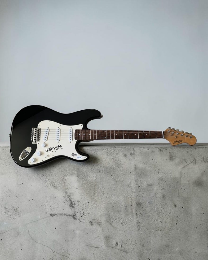 Angus Young AC/DC Signed Stratocaster Style Electric Guitar ACOA Authenticated: This lot is a Stratocaster style electric guitar, autographed by Angus Young of AC/DC. Item comes with ACOA authentication. If you wish to upgrade to a third party authentication with holographic QR