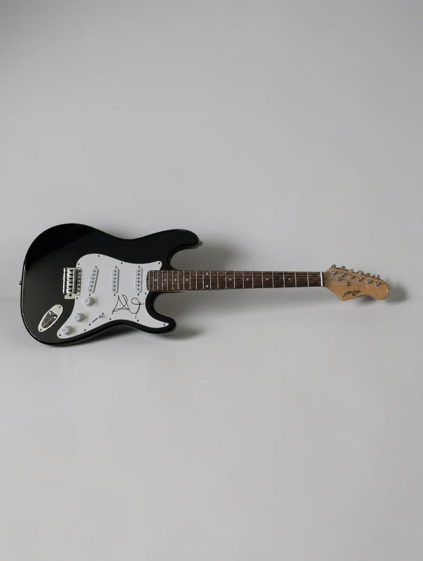 Alex Turner Arctic Monkeys Signed Stratocaster Style Electric Guitar: This lot is a Stratocaster style electric guitar, autographed by Alex Turner of Arctic Monkeys. If you wish to upgrade to a third party authentication with holographic QR code and item scoring, an add