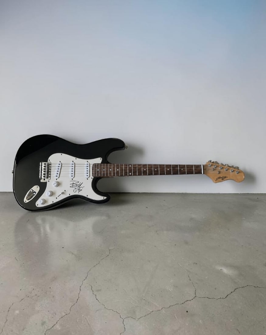 Billy Joe Armstrong Green Day Signed Stratocaster Style Electric Guitar: This lot is a Stratocaster style electric guitar, autographed by Billy Joe Armstrong of Green Day. If you wish to upgrade to a third party authentication with holographic QR code and item scoring, an 