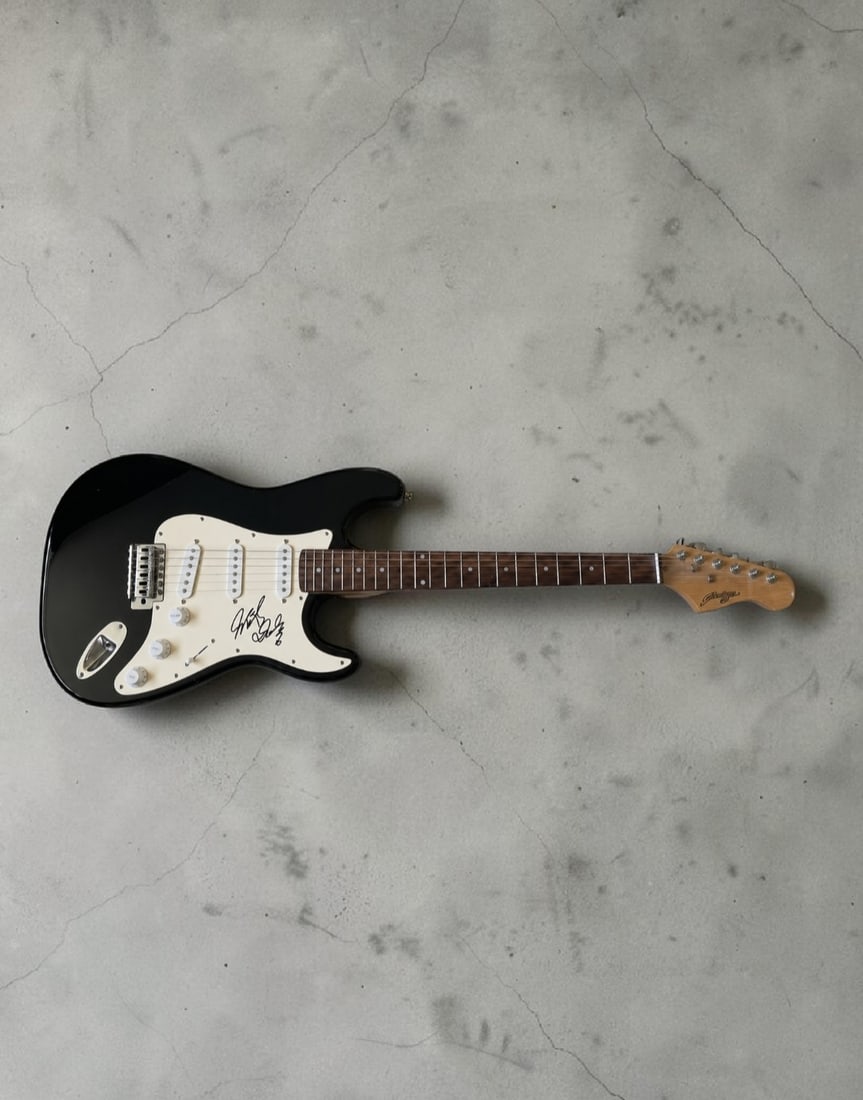 Micky Dolenz The Monkees Signed Stratocaster Style Electric Guitar: This lot is a Stratocaster style electric guitar, autographed by Mickey Dolenz of the Monkees. If you wish to upgrade to a third party authentication with holographic QR code and item scoring, an addi