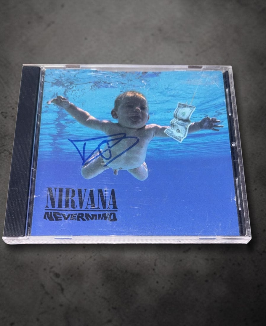 Dave Grohl Nirvana Signed CD: This lot is a CD (Nevermind), autographed by Dave Grohl of Nirvana. If you wish to upgrade to a third party authentication with holographic QR code and item scoring, an additional charge of 30 UK