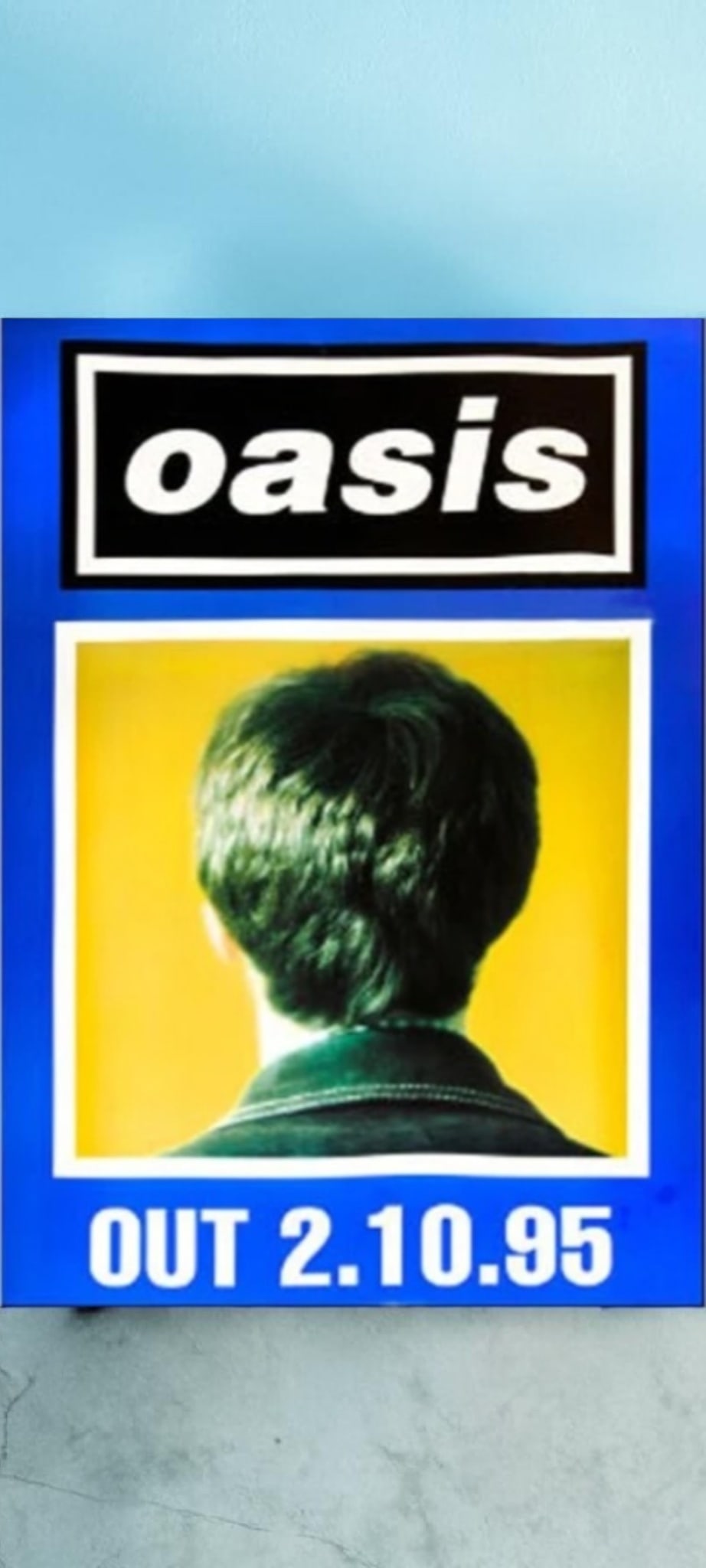 Oasis Original Promotional Poster: This lot is a 30x20" original (Oasis) promotional poster for the album release (What's The Story - Morning Glory?). This is a rare poster in blue featuring Noel Gallagher. Item comes with COA guarante