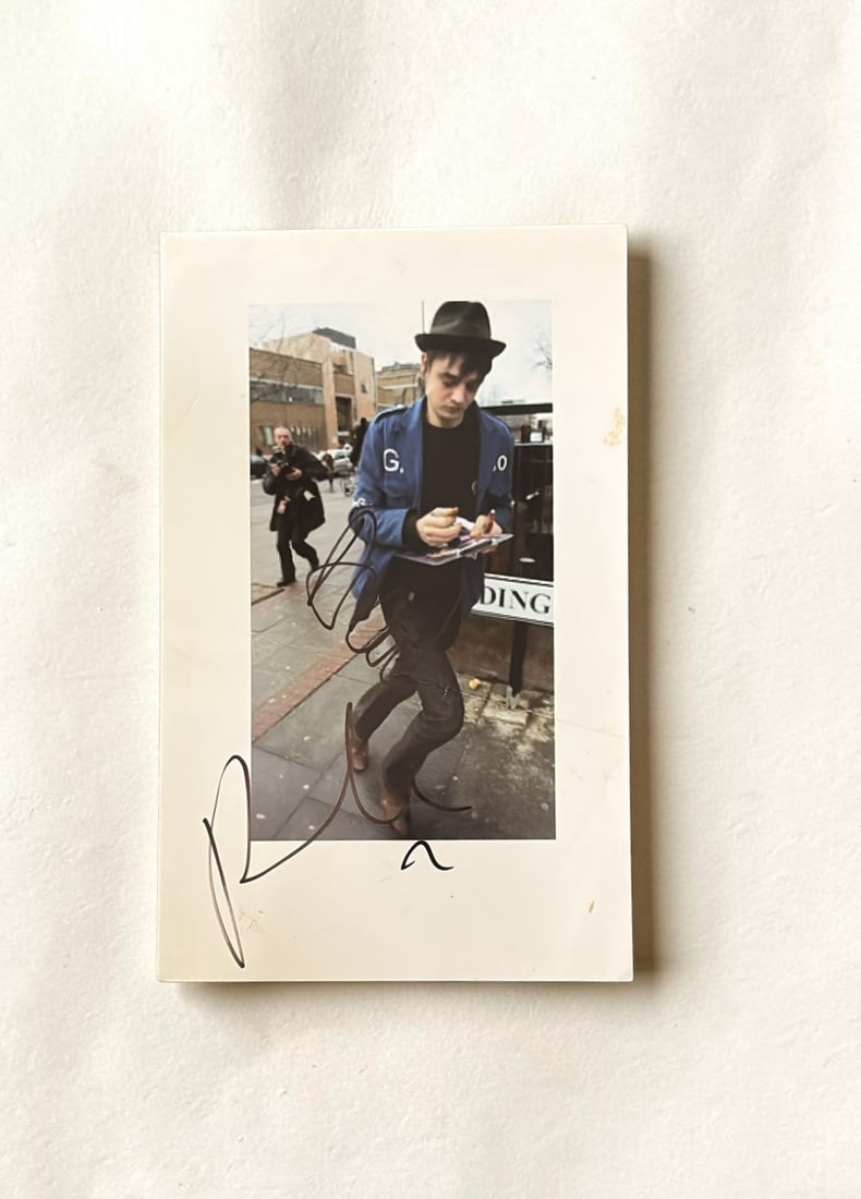 Pete Doherty Libertines Signed Vintage Early 2000's Print: This lot is a vintage print, early 2000's, with considerable wear, autographed by Pete Doherty of the Libertines. If you wish to upgrade to a third party authentication with holographic QR code and it