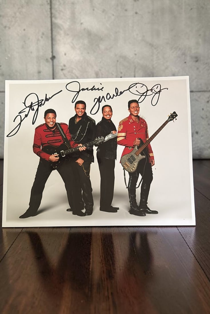 The Jacksons Signed Photograph: This lot is a 10x8" photograph, autographed by Tito, Jackie, Jermaine and Marlon of The Jacksons. If you wish to upgrade to a third party authentication with holographic QR code and item scoring, an a