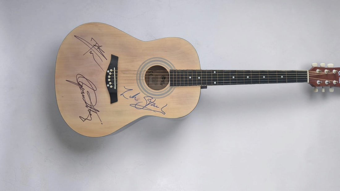The Who Signed Acoustic Guitar: This lot is an acoustic guitar, autographed on body by Roger Daltrey, Pete Townshend and Zak Starkey of The Who. If you wish to upgrade to a third party authentication with holographic QR code and ite