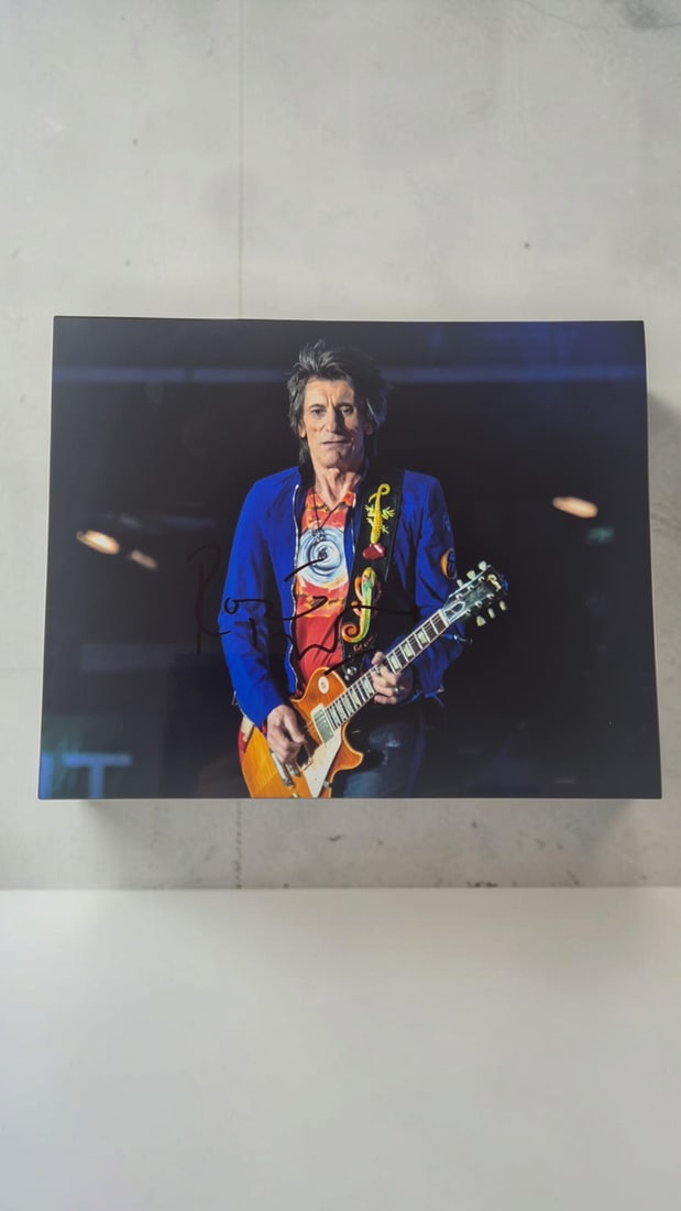 Ronnie Wood The Rolling Stones Signed Photograph: This lot is a photograph, autographed by Ronnie Wood of The Rolling Stones. If you wish to upgrade to a third party authentication with holographic QR code and item scoring, an additional charge of 30