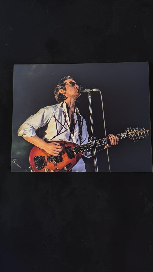 Alex Turner Arctic Monkeys Signed Photograph: This lot is a photograph, autographed by Alex Turner of Arctic Monkeys. If you wish to upgrade to a third party authentication with holographic QR code and item scoring, an additional charge of 30 UK
