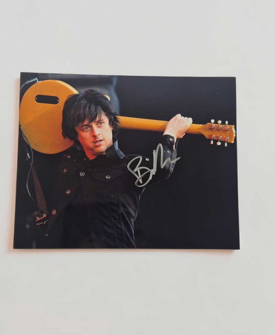 Billie Joe Armstrong Green Day Signed Photograph: This lot is a photograph, autographed by Billie Joe Armstrong of Greenday. If you wish to upgrade to a third party authentication with holographic QR code and item scoring, an additional charge of 30 