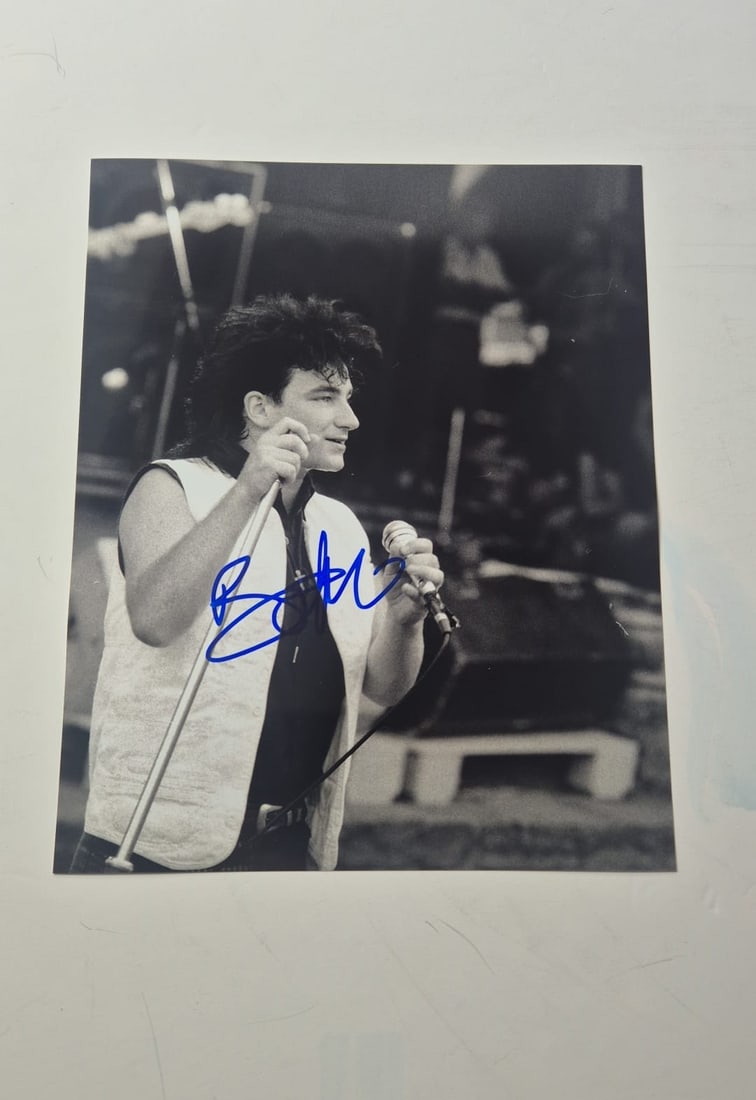 Bono U2 Signed Photograph: This lot is a photograph, autographed by Bono of U2. If you wish to upgrade to a third party authentication with holographic QR code and item scoring, an additional charge of 30 UK pound would be