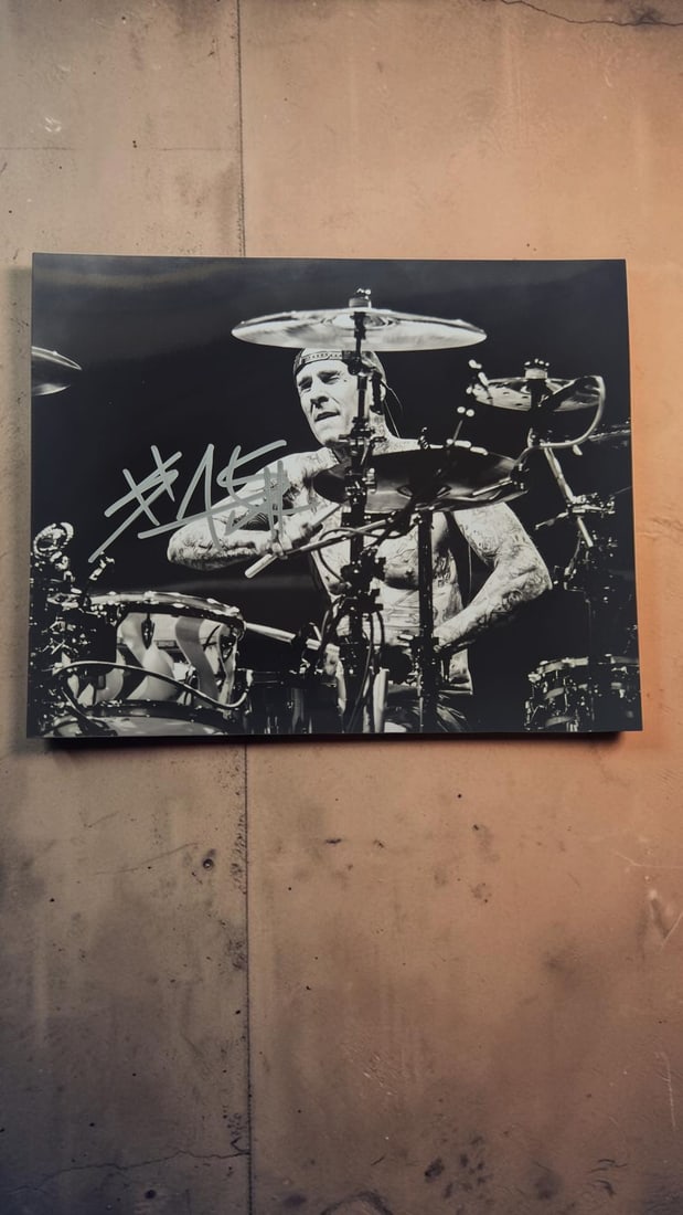 Travis Barker Blink-182 Signed Photograph: This lot is a photograph, autographed byTravis Barker of Blink-182. If you wish to upgrade to a third party authentication with holographic QR code and item scoring, an additional charge of 30 UK