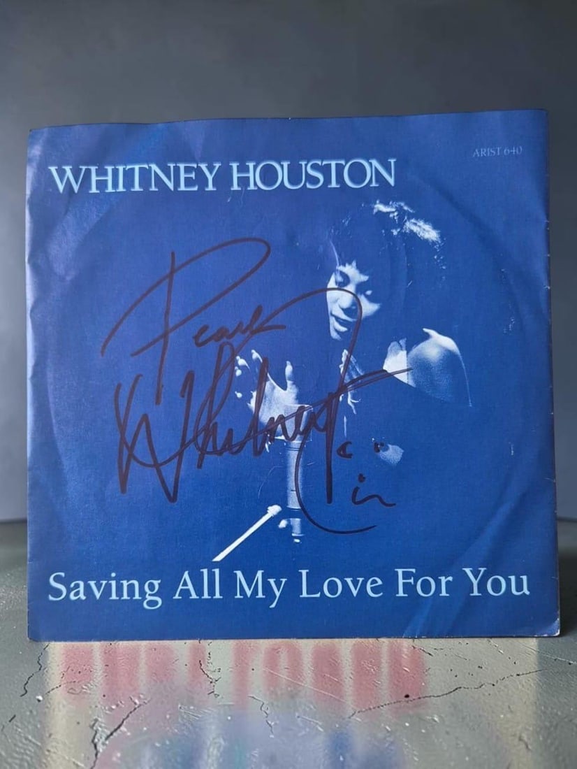 Whitney Houston Saving All My Love Signed 7" Vinyl: This lot is a 7" vinyl (Saving All My Love), autographed by Whitney Houston. If you wish to upgrade to a third party authentication with holographic QR code and item scoring, an additional charge of 3