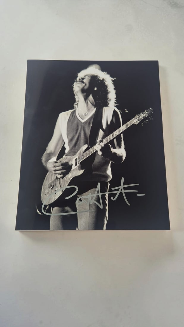 Carlos Santana Signed Photograph: This lot is a photograph, autographed by Carlos Santana. If you wish to upgrade to a third party authentication with holographic QR code and item scoring, an additional charge of 30 UK pound would be 