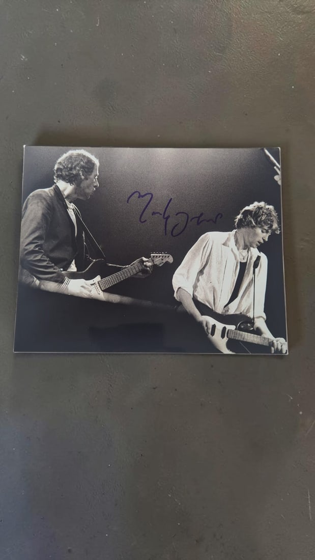 Mark Knopfler Dire Straites Signed Photograph: This lot is a photograph, autographed by Mark Knopfler of Dire Straites. If you wish to upgrade to a third party authentication with holographic QR code and item scoring, an additional charge of 30 UK