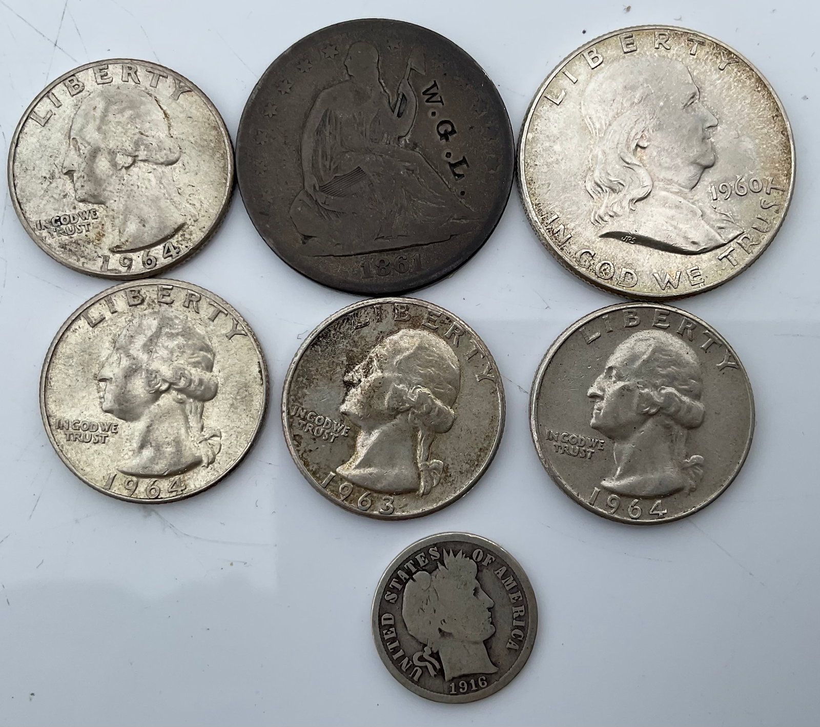 Group of 7 90 percent silver coins: Group of 7 90 percent silver coins. 1960 half dollar, 1861 half dollar, 3 1964 quarters, 1 1963 quarter, 1 1916 mercury dime