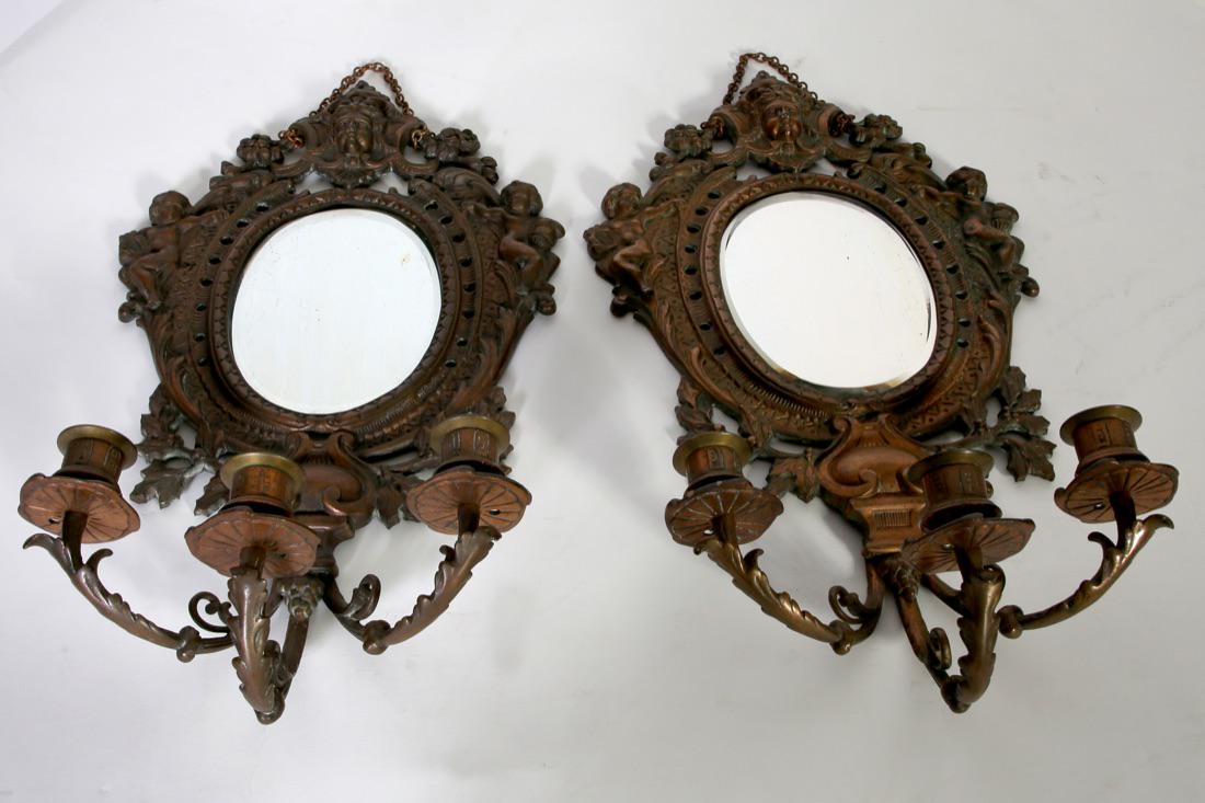 Pair Of Victorian Ornate Bronze Wall Sconces: Pair Of Victorian Bronze Ornate Three Candle Beveled Mirror Wall Sconces With Cherubs. Condition:Good,minor wear and scratches. Size: 11" D x 19 1/2" H